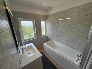 a bathroom with a tub and a sink and a shower at Villa Jeanne in Saint-Nazaire-en-Royans +17 photos