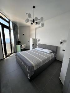 a bedroom with a large bed with a view of the ocean at 11 Апартамент с отдельной спальней in Kvariati