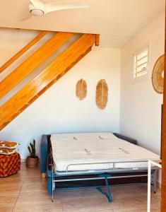 a bedroom with a bed in the attic at Gîte Belle Place in Le Gosier