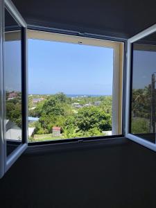 a window in a room with a view at Gîte Belle Place in Le Gosier