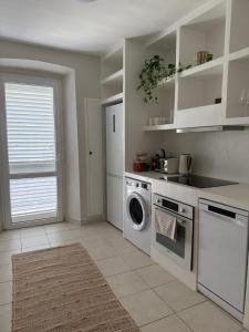 a kitchen with a washing machine and a dishwasher at Apartment Korčula in Korčula +6 photos