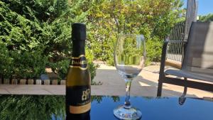 a bottle of wine and a glass on a table at a due passi dal mare in Campofelice di Roccella