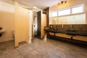 a bathroom with two sinks and a mirror at Centre de l'Hêtre in Lac-Beauport +66 photos