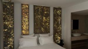 a bedroom with a bed with lights on the wall at Bobo's hotel in Paris