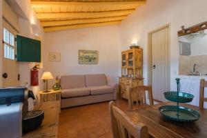 a living room with a couch and a table at Aldeia da Pedralva by WOT Signature in Vila do Bispo