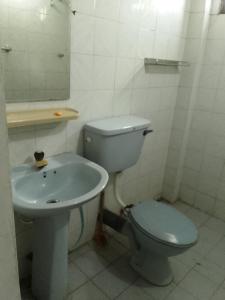 a bathroom with a toilet and a sink at Dune Villa in Hikkaduwa