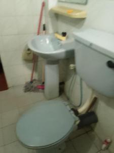 a bathroom with a toilet and a sink at Dune Villa in Hikkaduwa