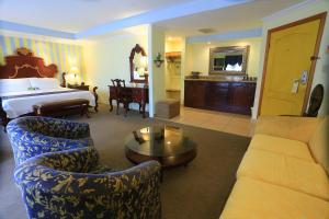 a hotel room with a bed and a living room at Boutique Hotel La Cordillera in San Pedro Sula +38 photos