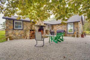 a stone house with a table and chairs in front of it at Fish, Hike and Golf Countryside Retreat in Bluffton in Bluffton