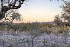 a view of a field with trees and a fence at Twisted Horns Ridge and Ranch in Hondo