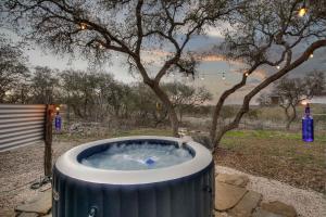 a hot tub in a yard with a tree at Twisted Horns Ridge and Ranch in Hondo