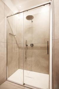 a shower with a glass door in a bathroom at La Casina di Luca in Rimini