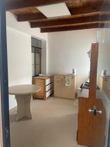 a kitchen with a table in the middle of a room at Casa Ruiz Ganoza in San Antonio