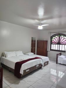 a bedroom with a large bed and a window at Pousada Sinhá Moça in Diamantina +263 photos