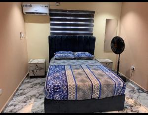 a bedroom with a bed with a black head board at Excell and be Great Homes in Lagos +3 photos