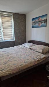 a bedroom with a large bed in a room at Apartman Katja Travnik in Travnik