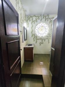 a bathroom with a toilet and a sink with a window at Pousada Sinhá Moça in Diamantina +263 photos