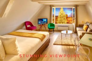 a room with a bed and a christmas tree out the window at The POINT CITY-Center - Place KLEBER in Strasbourg