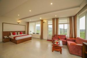 a hotel room with a bed and a couch at Heavenly Hills 4 BHK Villa - 1 Bedroom in Kotagiri