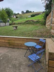 a table and two chairs sitting on a porch at Maison basque in Saint-Étienne-de-Baïgorry +3 photos