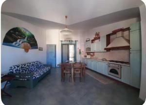 a kitchen with a bed and a table in a room at Casa Bella Vista in Villasimius