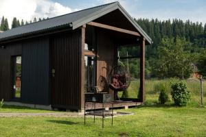 a small shed with a basket on the porch at Bliss Cottage in Slavske
