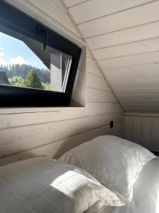 a bedroom with a window and a bed in a room at Bliss Cottage in Slavske +42 photos