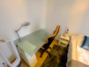 a bedroom with a desk and a bed and a desk with a chair at One-bedroom apartment with free parking in Oulu +29 photos