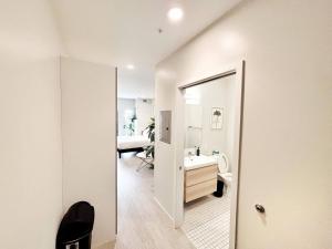 a white bathroom with a sink and a mirror at Tranquil Escape in Des Moines