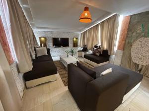 a living room with a couch and a tv at King Apartment in Flic-en-Flac