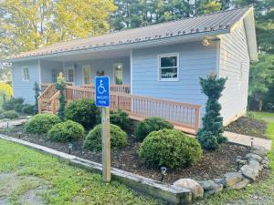 a small house with a handicapped sign in front of it at Flower Bliss Cottage in Sparta Mountains in Sparta