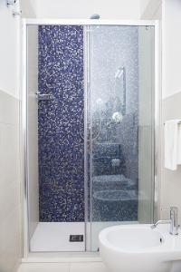 a bathroom with a shower and a toilet and a sink at B&B Villa Tiziano in Terracina