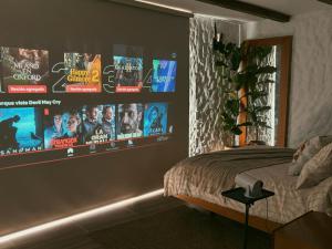 a bedroom with a bed and posters on the wall at Glamping La Cima in San Gil