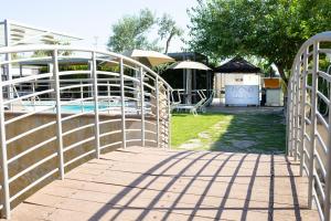 a wooden walkway leading to a swimming pool at Giardini di Marzo Lecce B&B in Lecce