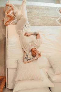 a man is laying on a bed at Zen House 7 - Villas & Spa in Morin Heights