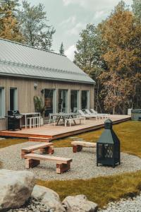 a house with a deck and benches in front of it at Zen House 7 - Villas & Spa in Morin Heights +102 photos