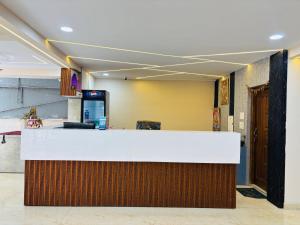 a lobby with a white and brown counter top at Hotel PANDIT PALACE in Visakhapatnam