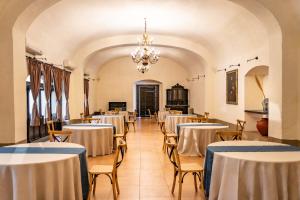 a dining room with tables and chairs and a chandelier at Quinta Real Puebla in Puebla