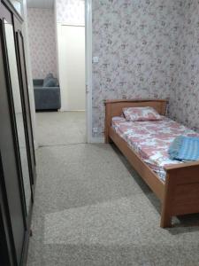 a small bedroom with a bed and a couch at Lom Bulgarana in Bourg-Argental +4 photos