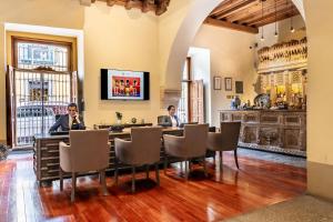 two people sitting at a table in a room at Quinta Real Puebla in Puebla