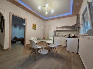 a kitchen with a table and chairs in a room at Chrysalis House in Nea Potidaea