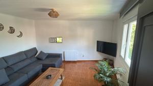 a living room with a couch and a tv at Villa Mallorquina tu zona para desconectar in Jacébanes