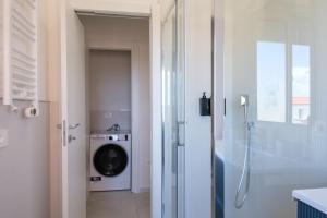 a bathroom with a washing machine and a shower at Casa Bea & Gin - Via Giacomo Matteotti 2A in Sassari +38 photos
