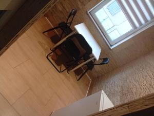 a chair sitting on a table in a room with a window at Miczurina in Wałbrzych +4 photos
