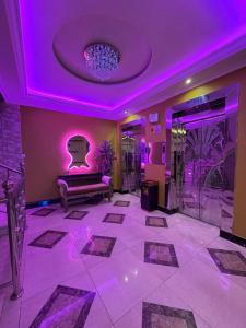 a room with a purple lighting and a couch at Nova Park Serviced Apartments - نووا بارك للشقق المخدومة in Yanbu