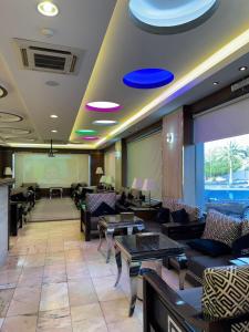 a restaurant with couches and tables in a room at Nova Park Serviced Apartments - نووا بارك للشقق المخدومة in Yanbu