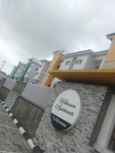 a sign on the side of a building at Willcrown apartments in Lagos