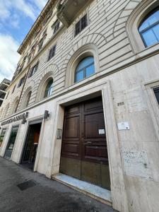 a stone building with two doors on the side of it at Joe Litty Rooms in Rome
