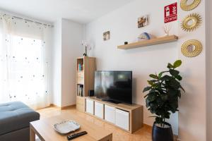 a living room with a couch and a television at Vacaciones Aguilas con Aire Acondicionado y Wifi - by Aloha Palma in Águilas +21 photos
