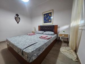 a bedroom with a bed with a blue comforter at Chrysalis House in Nea Potidaea